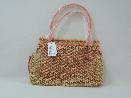 Back view of coral woven net tote with beech wood top bar, leather trim and removable Goyardine canvas inner pouch.