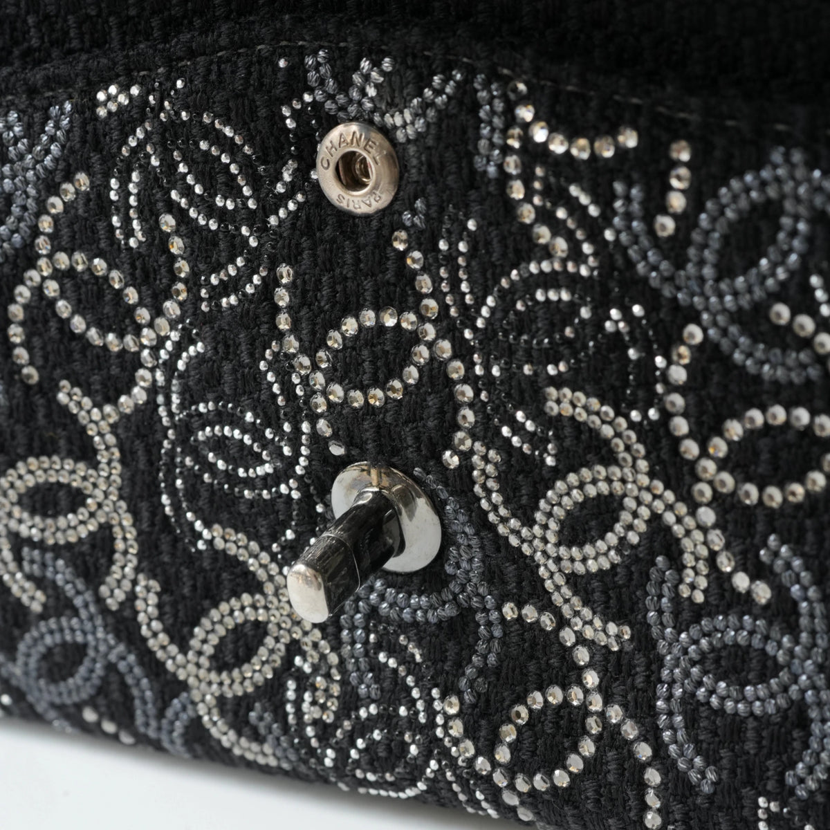 Detail view of silver interlocking CC turnlock and crystal embellishments