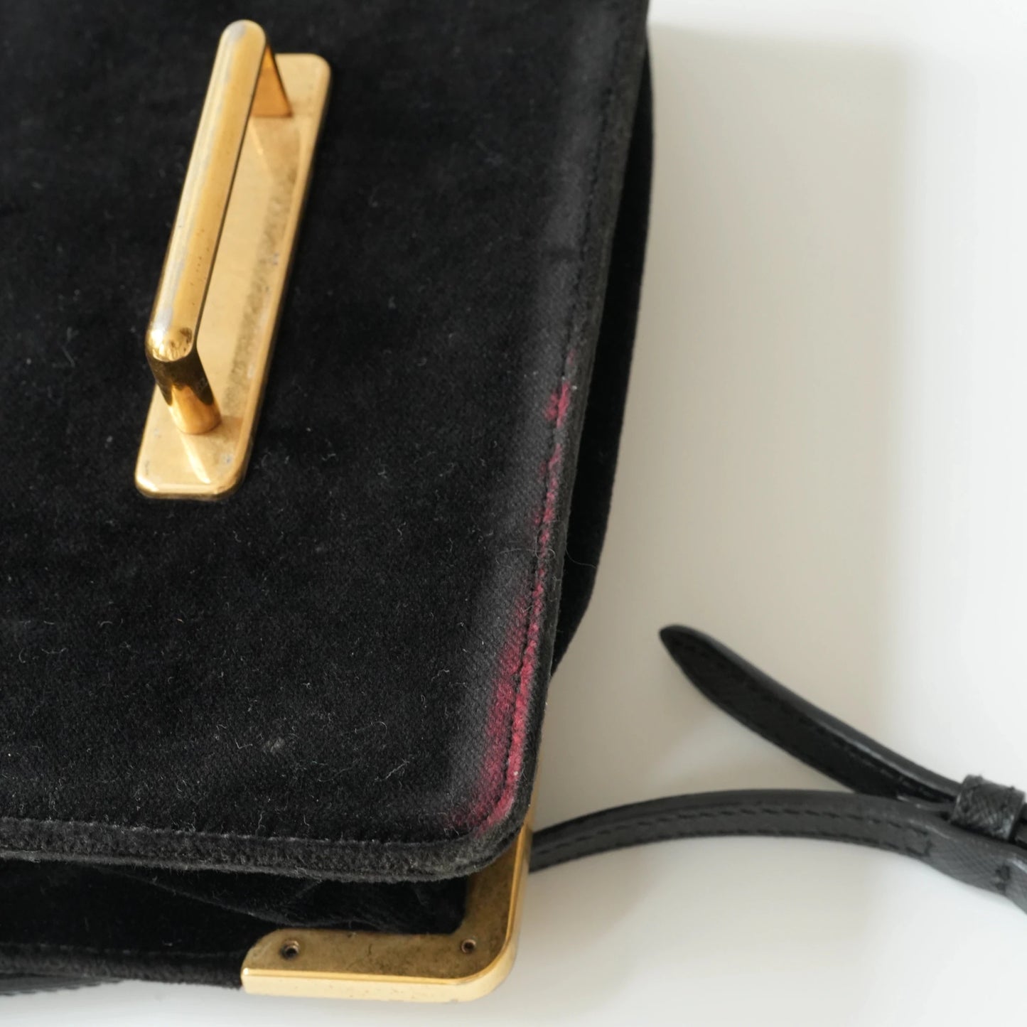 Detail view of gold Prada logo and celestial metal embellishments