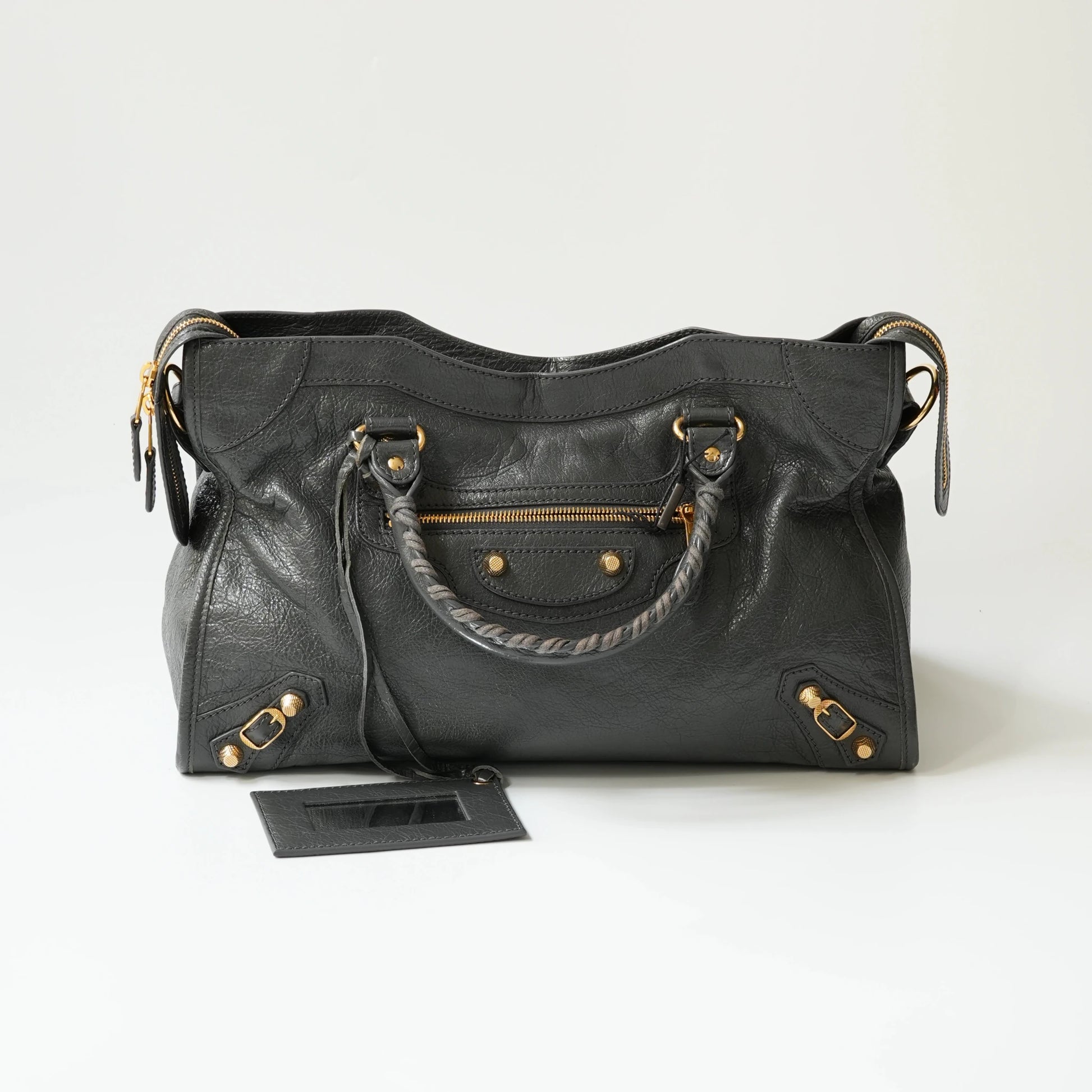 Grey Balenciaga Classic City bag front view with gold hardware, iconic moto design with braided handle and rivet details