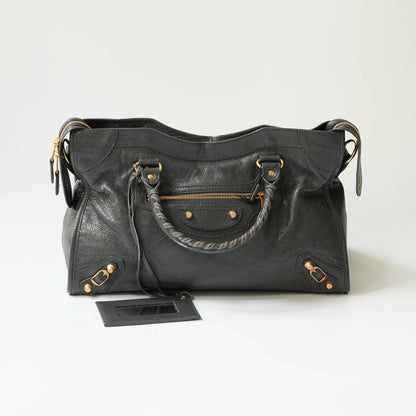 Grey Balenciaga Classic City bag front view with gold hardware, iconic moto design with braided handle and rivet details