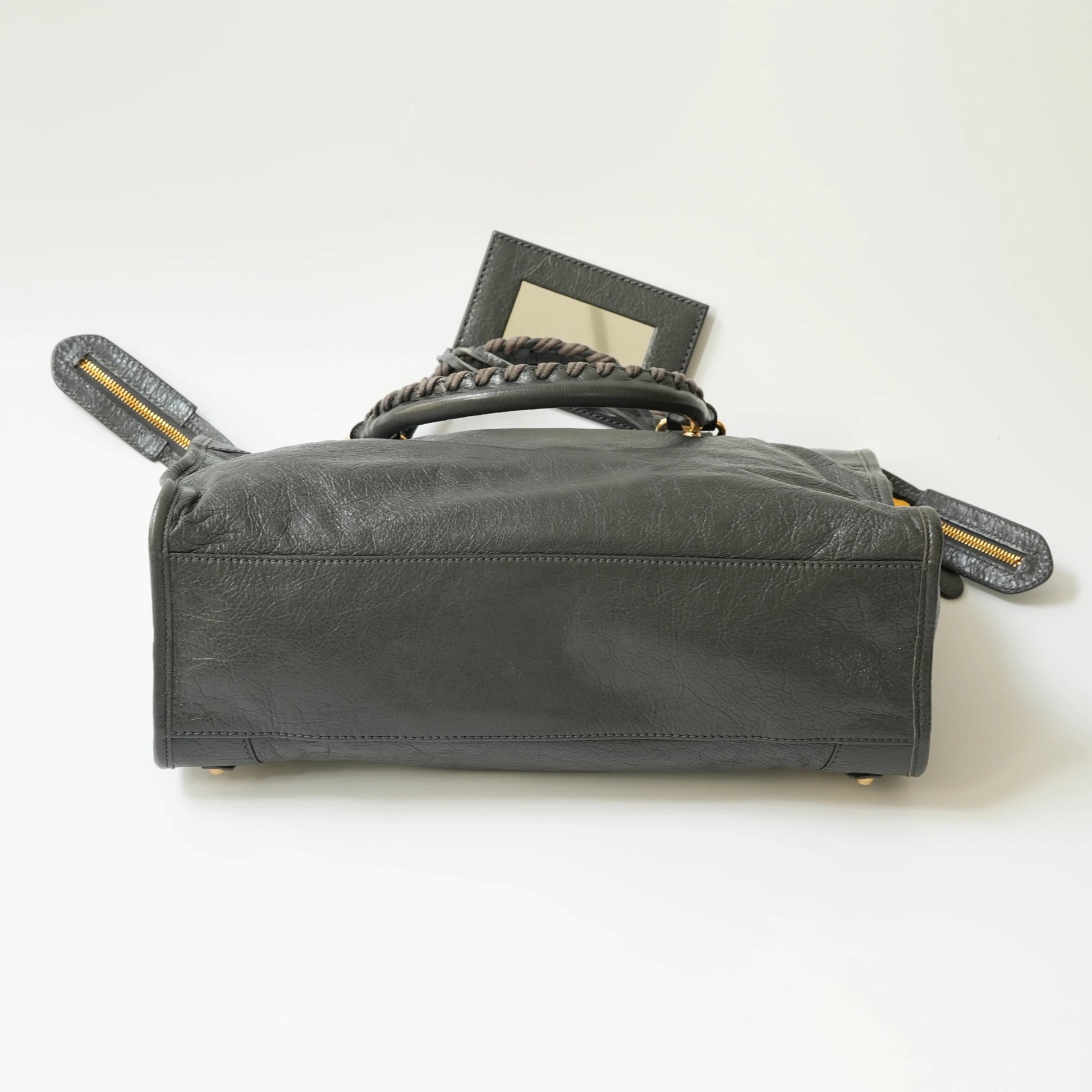 Balenciaga Classic City grey bag bottom view with gold hardware, reinforced leather base with protective studs