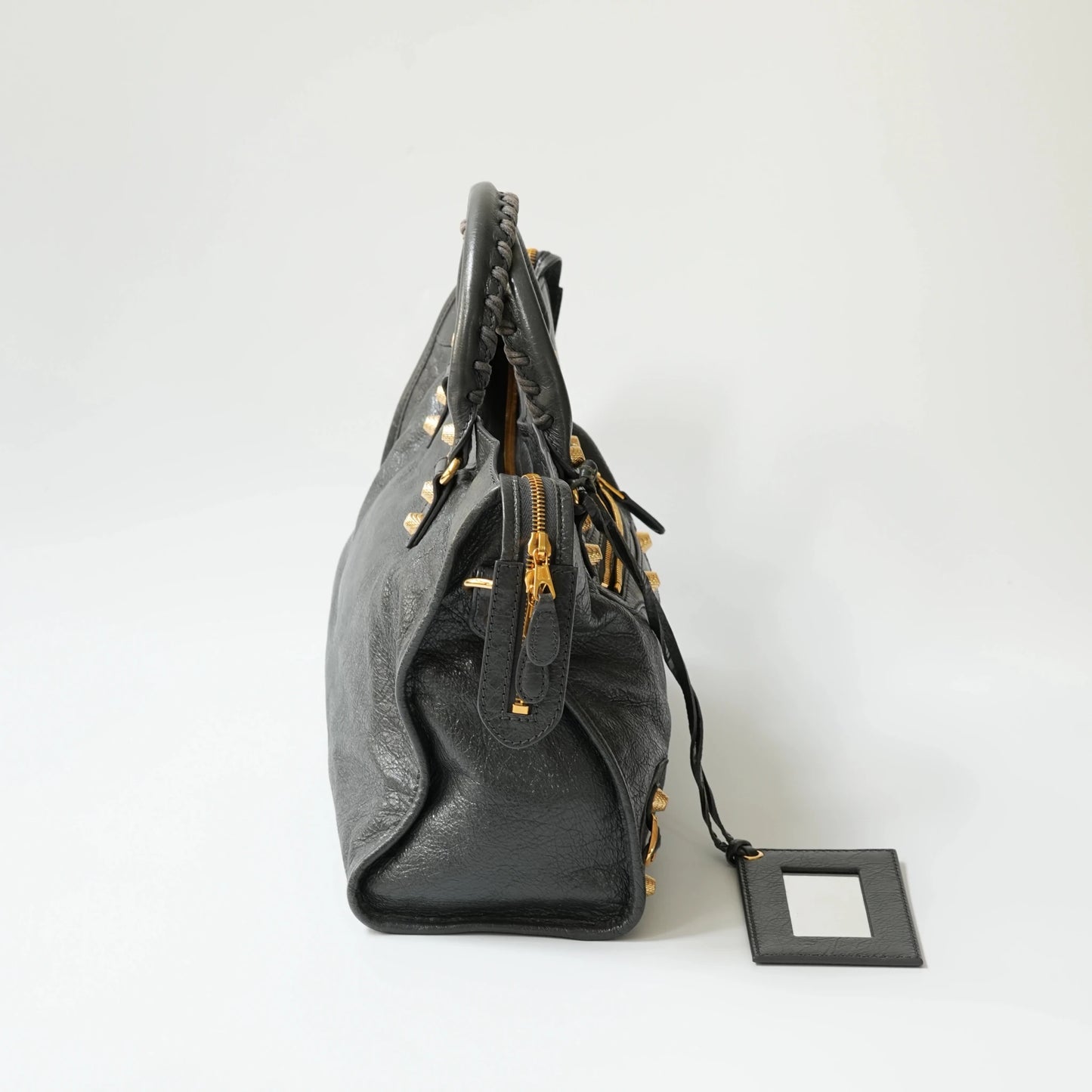Balenciaga Classic City grey bag side view with gold hardware, soft structured silhouette with side zip detail