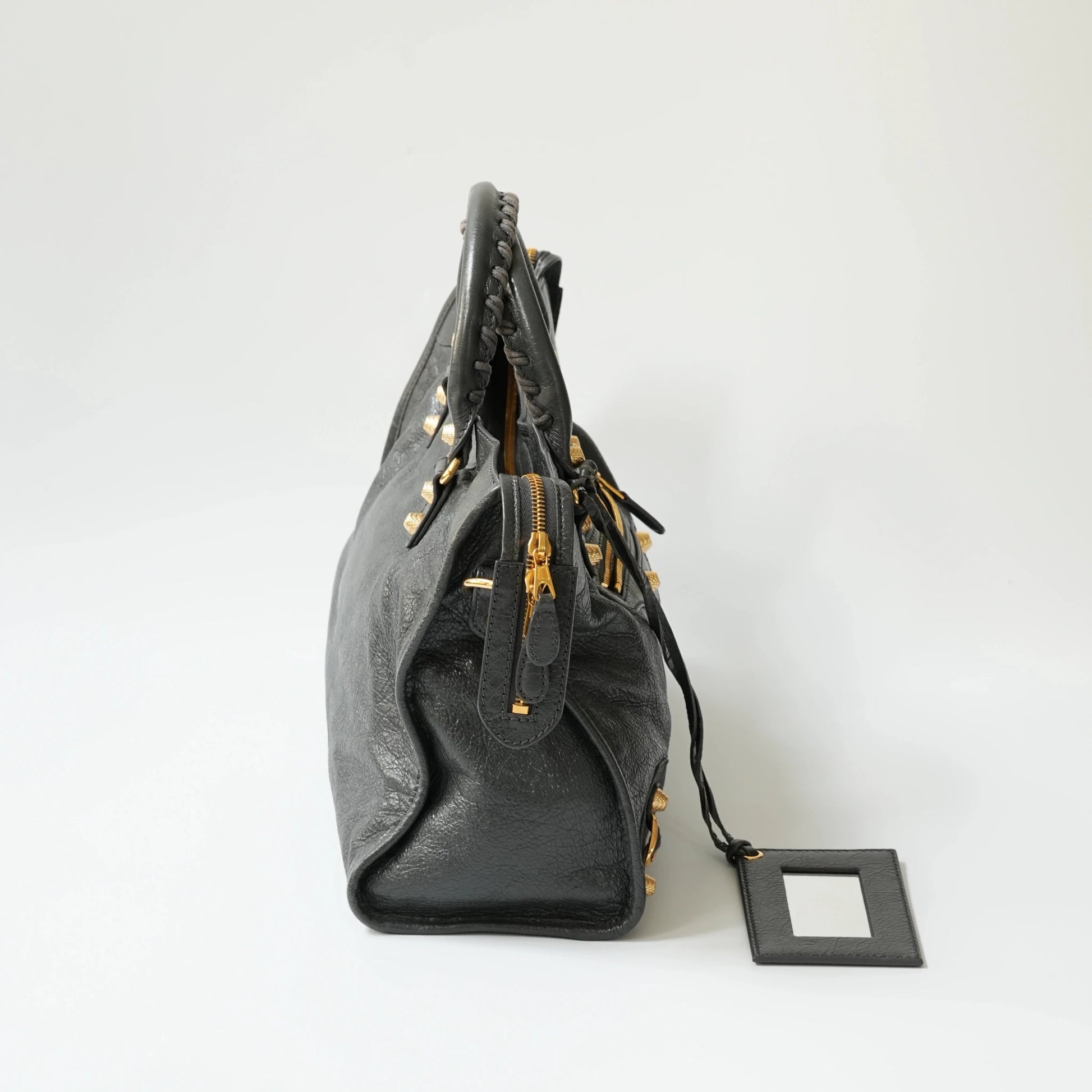 Balenciaga Classic City grey bag side view with gold hardware, soft structured silhouette with side zip detail