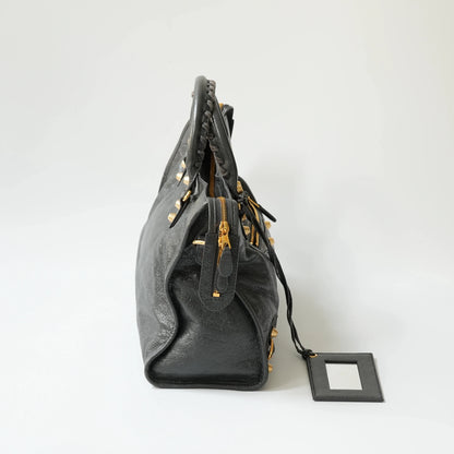 Balenciaga Classic City grey bag side view with gold hardware, soft structured silhouette with side zip detail