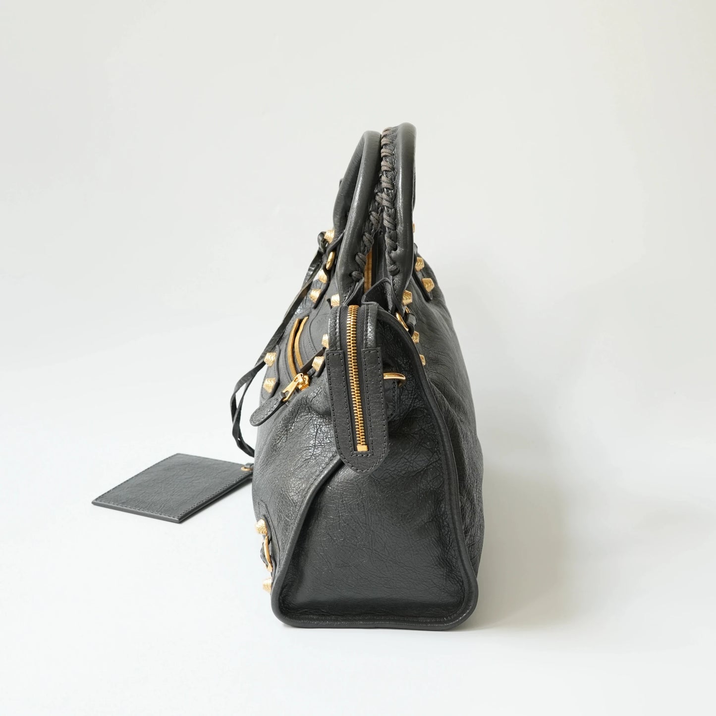Balenciaga Classic City grey bag side view with gold hardware, soft structured silhouette with side zip detail