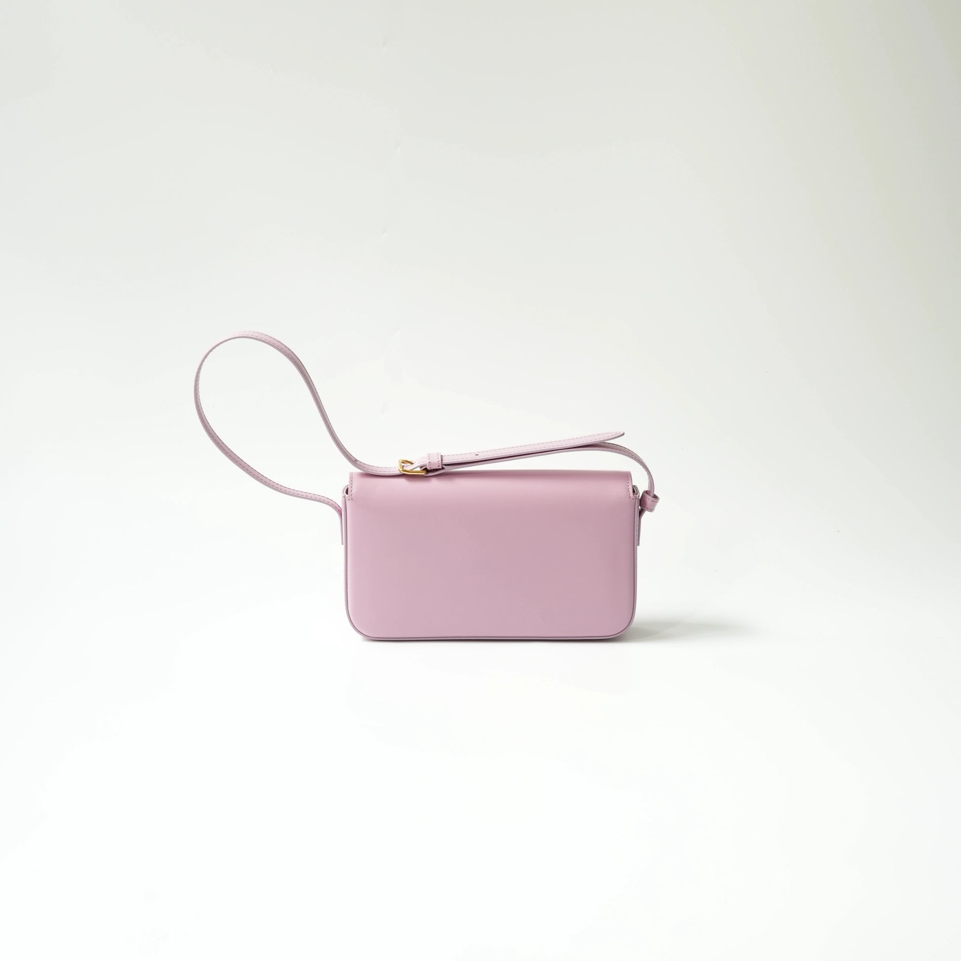 Back view of lavender shiny calfskin Triomphe bag with gold Triomphe clasp and adjustable matching leather strap.