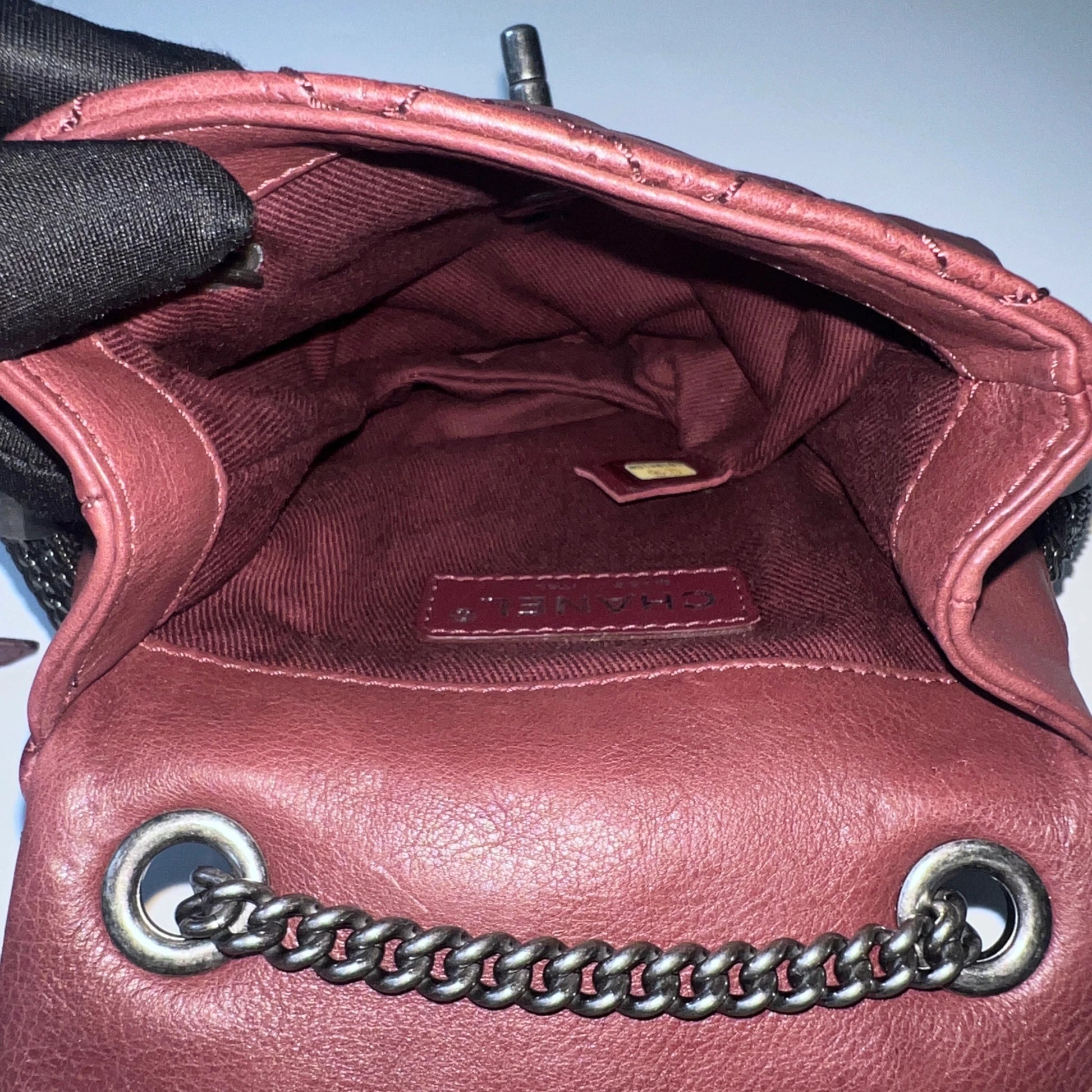 Interior view of Chanel mini flap bag with fabric lining and compact storage compartment