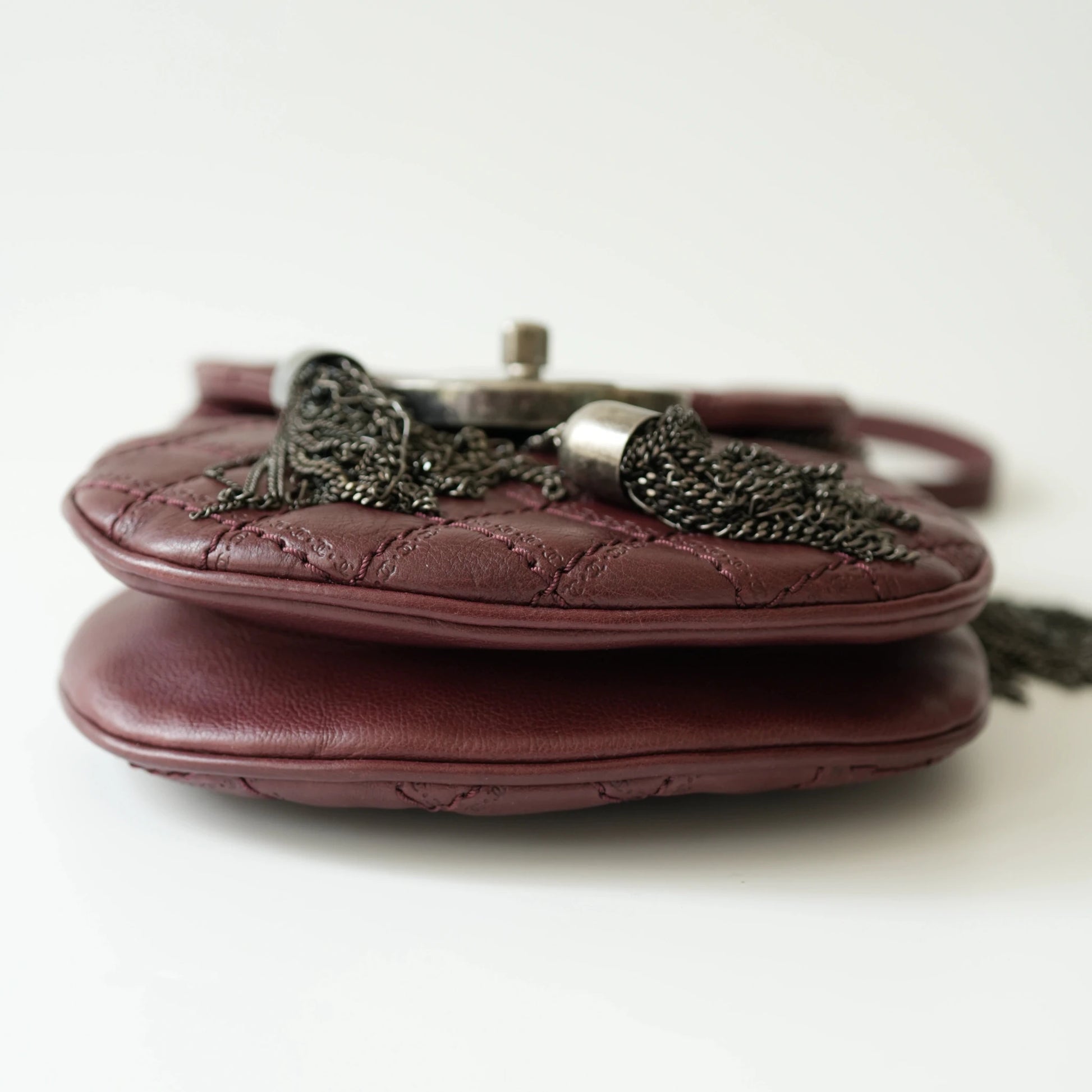 Bottom view of Chanel mini crossbody bag with neat base stitching and structured shape