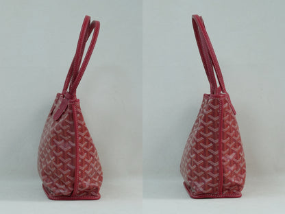 Side view of the red Goyardine herringbone canvas mini reversible tote bag, featuring calfskin trim and double handles.