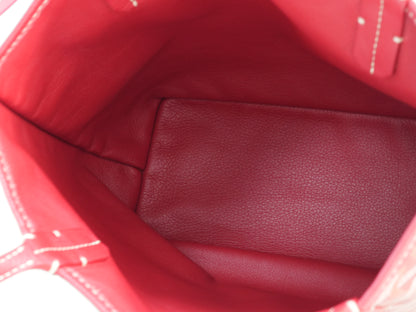 Interior view of the red Goyardine herringbone canvas mini reversible tote bag, featuring calfskin trim and double handles.