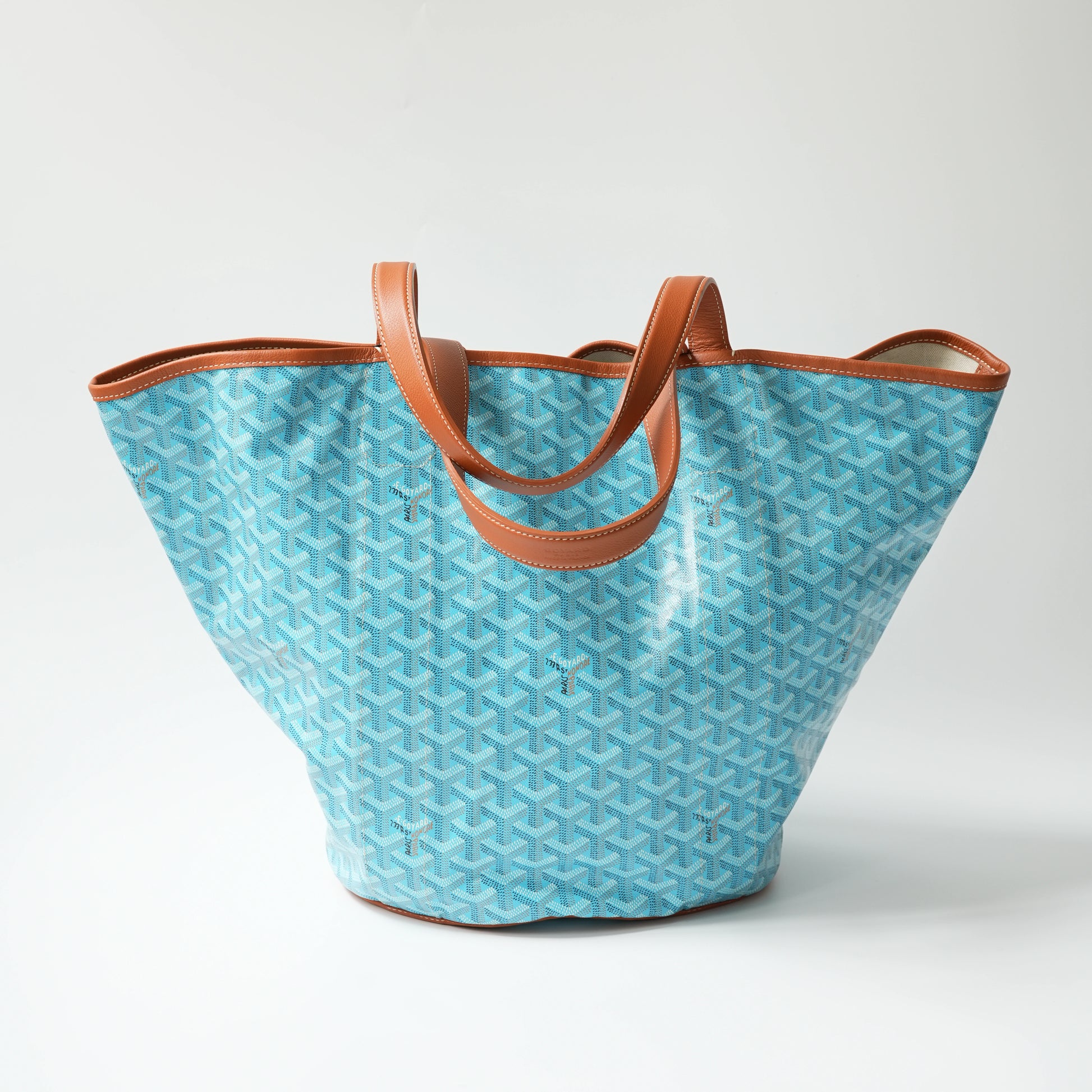 Back view: Back view of Goyard Belharra tote, full chevron monogram pattern with leather edge binding and flat base