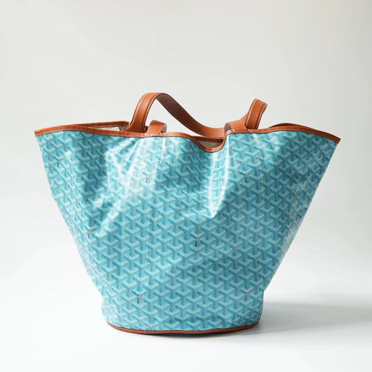 Front view: Front view of Goyard Belharra MM reversible tote, turquoise Goyardine canvas with cognac brown calfskin trim and dual top handles