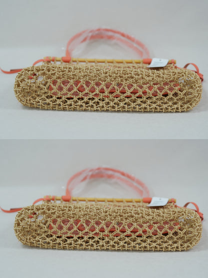 Bottom view of coral woven net tote with beech wood top bar, leather trim and removable Goyardine canvas inner pouch.