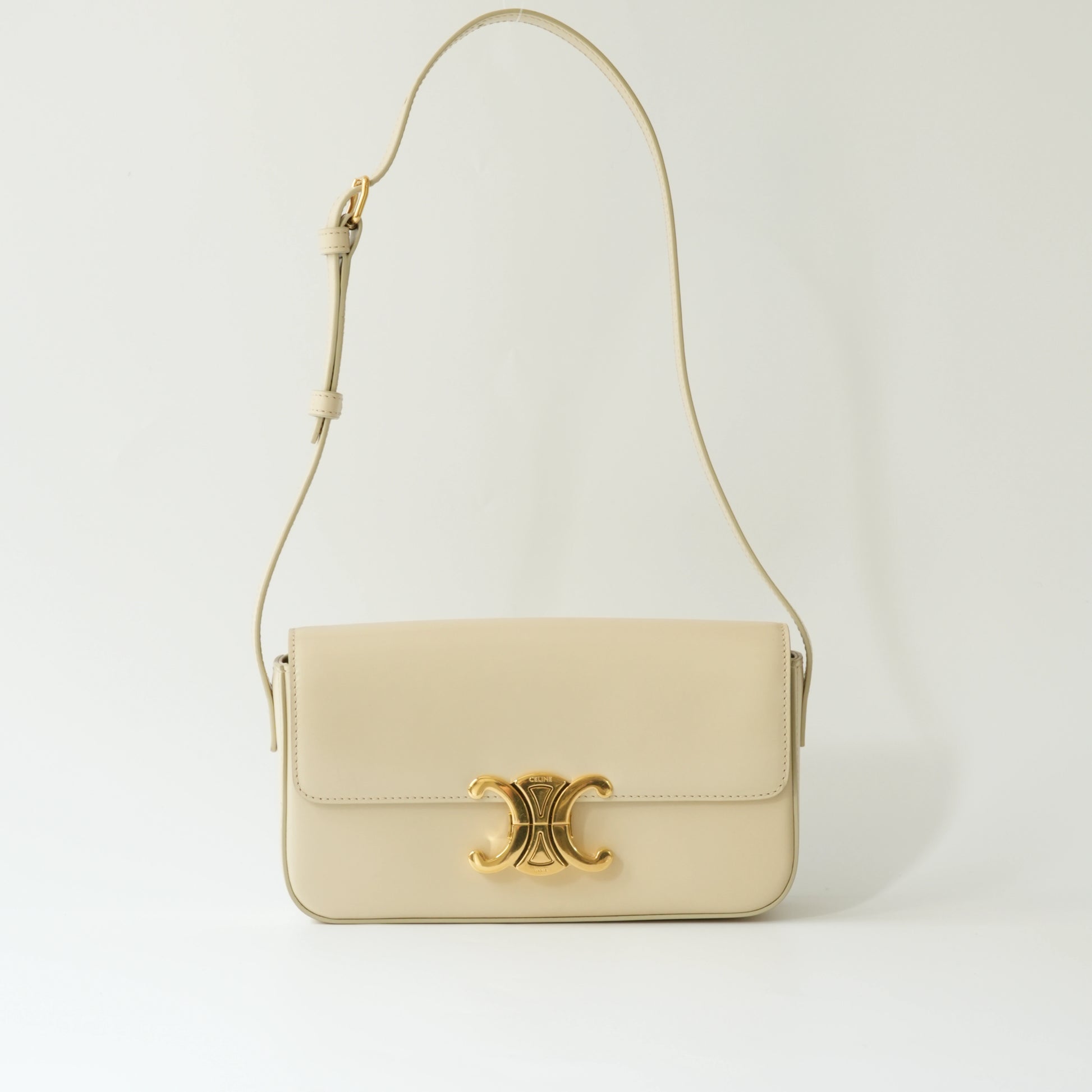 Front view of Celine Triomphe shoulder bag in ivory shiny calfskin with gold Triomphe clasp