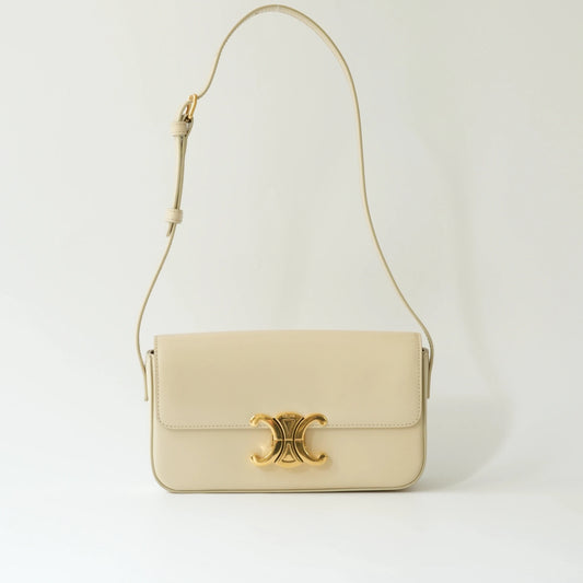 Front view of Celine Triomphe shoulder bag in ivory shiny calfskin with gold Triomphe clasp