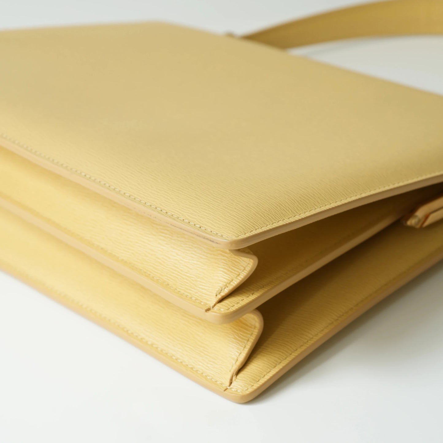 Detail view of Celine clasp bag precision leather stitching and high-shine metal hardware