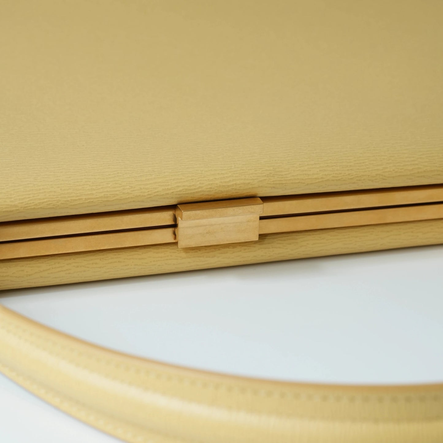Detail view of Celine clasp bag precision leather stitching and high-shine metal hardware