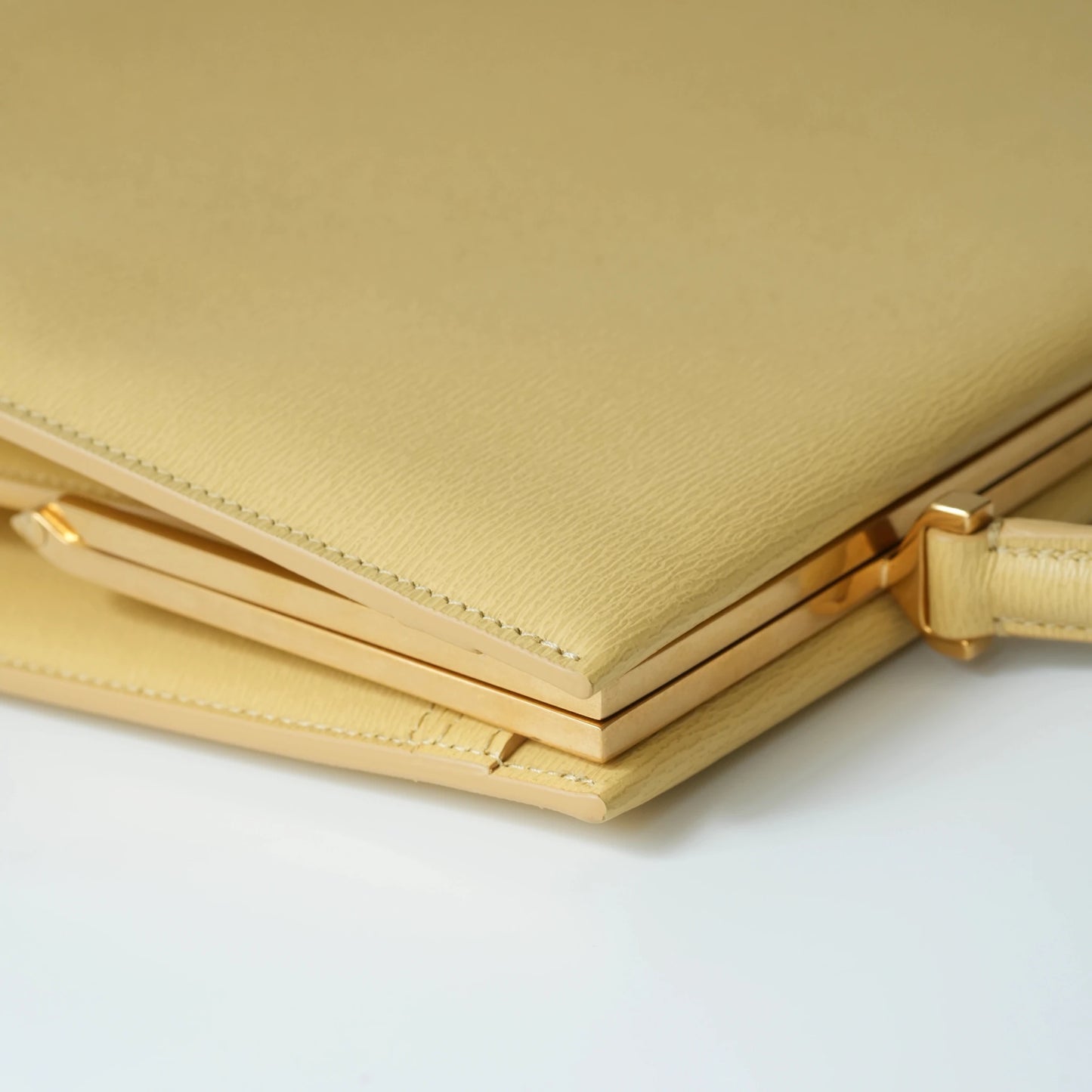 Detail view of Celine clasp bag precision leather stitching and high-shine metal hardware