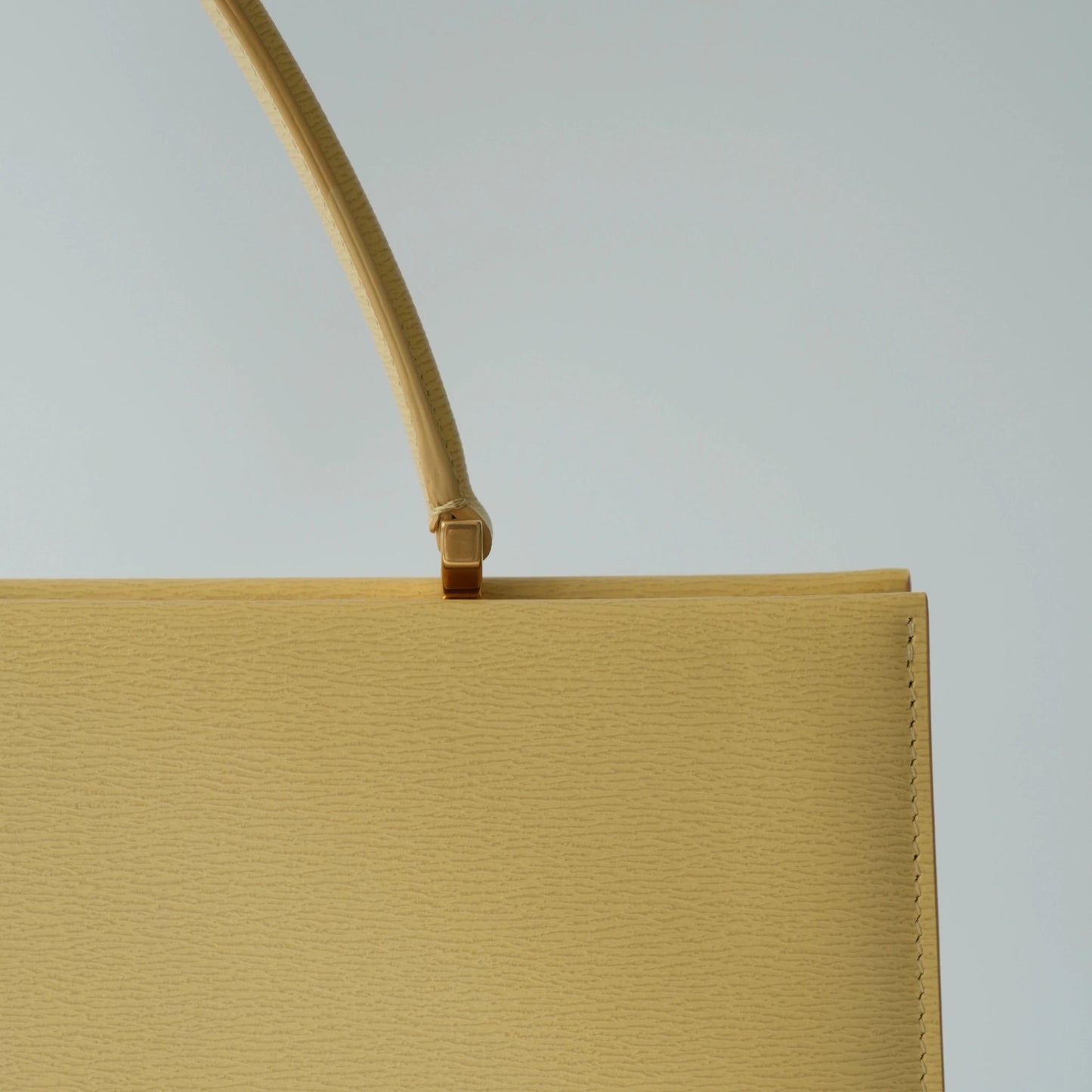 Detail view of Celine clasp bag precision leather stitching and high-shine metal hardware