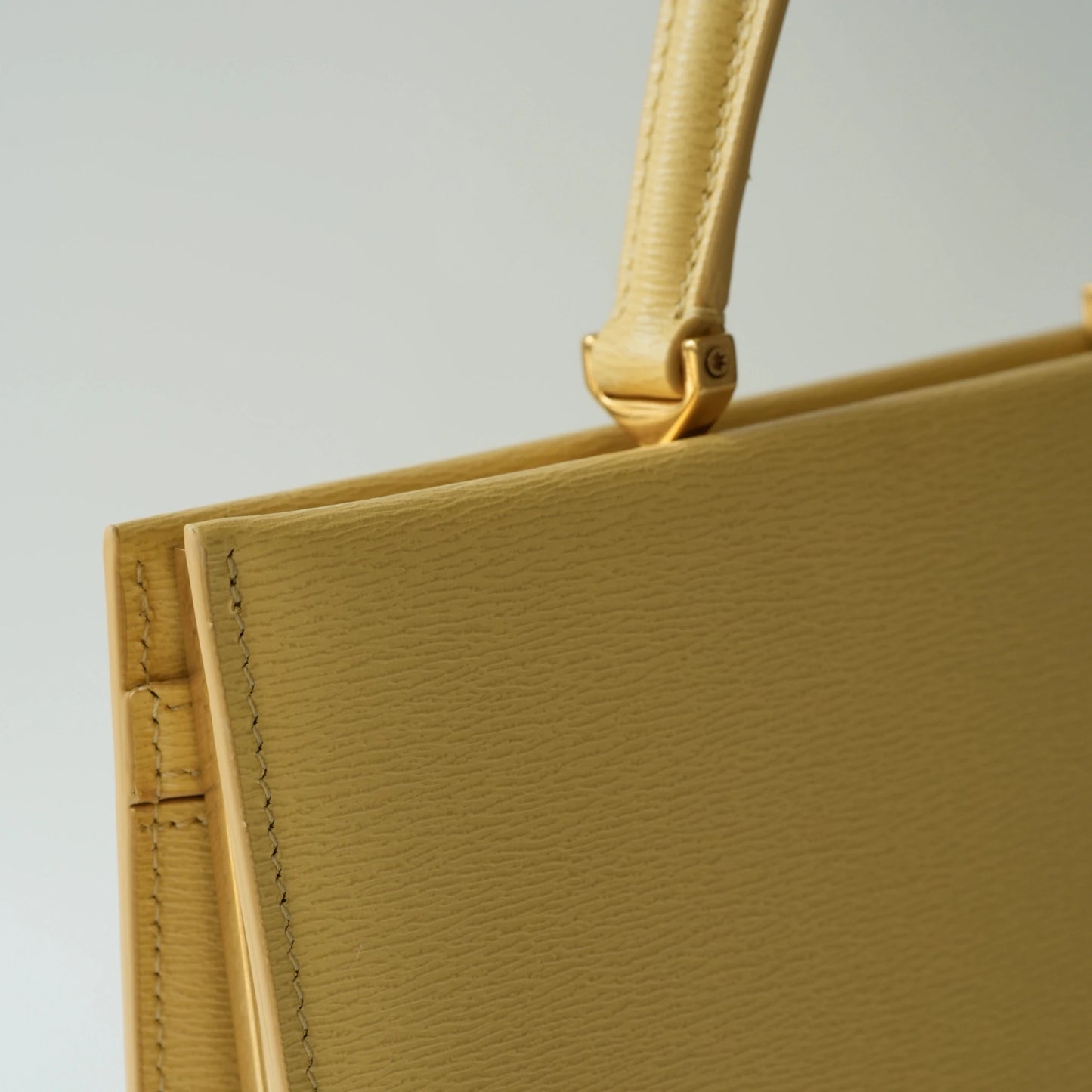 Detail view of Celine clasp bag precision leather stitching and high-shine metal hardware