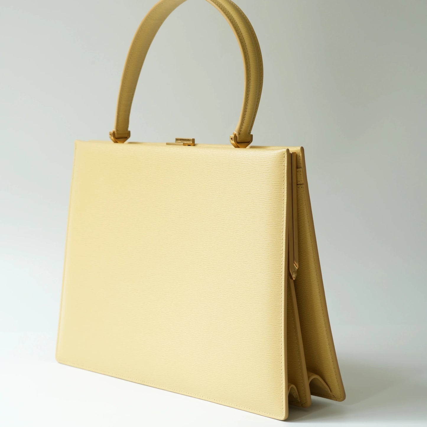 Detail view of Celine clasp bag precision leather stitching and high-shine metal hardware