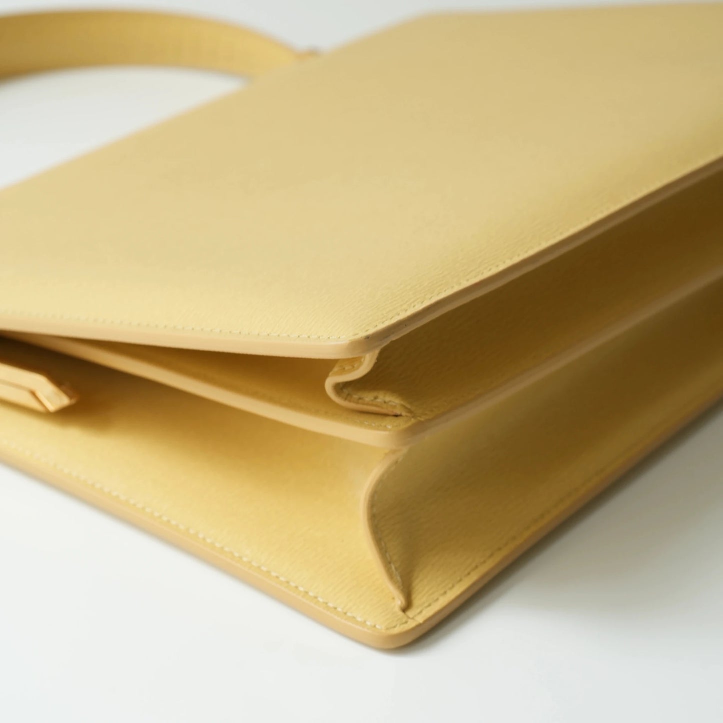 Detail view of Celine clasp bag precision leather stitching and high-shine metal hardware