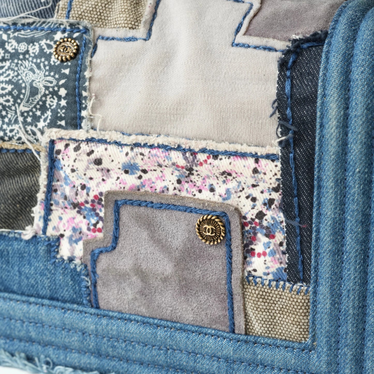 Detail view of aged gold Boy clasp and patchwork denim fabric details