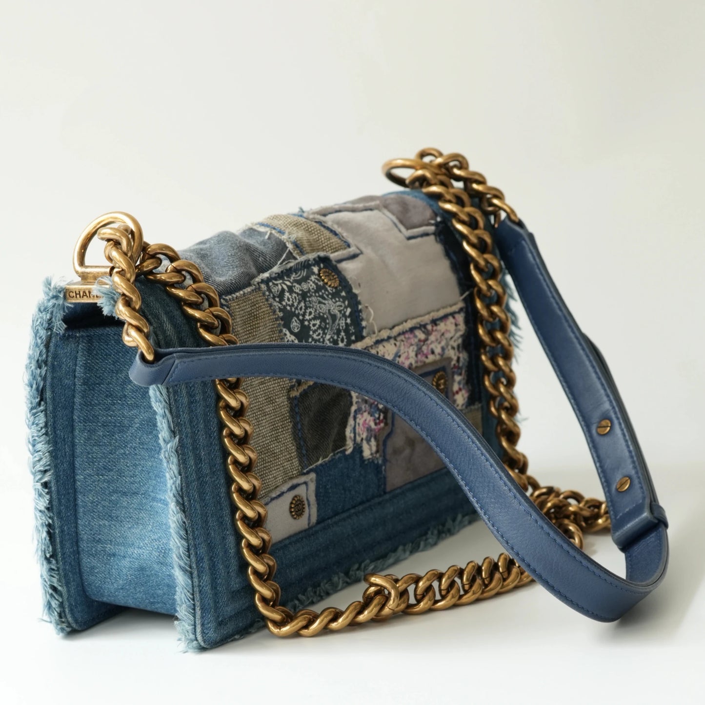 Detail view of aged gold Boy clasp and patchwork denim fabric details