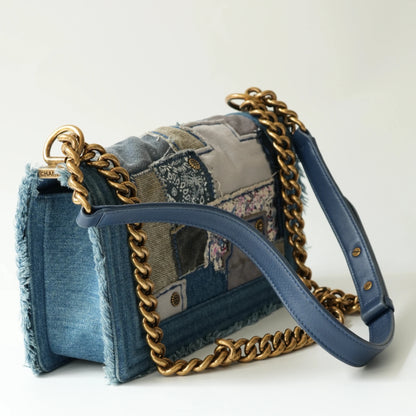 Detail view of aged gold Boy clasp and patchwork denim fabric details