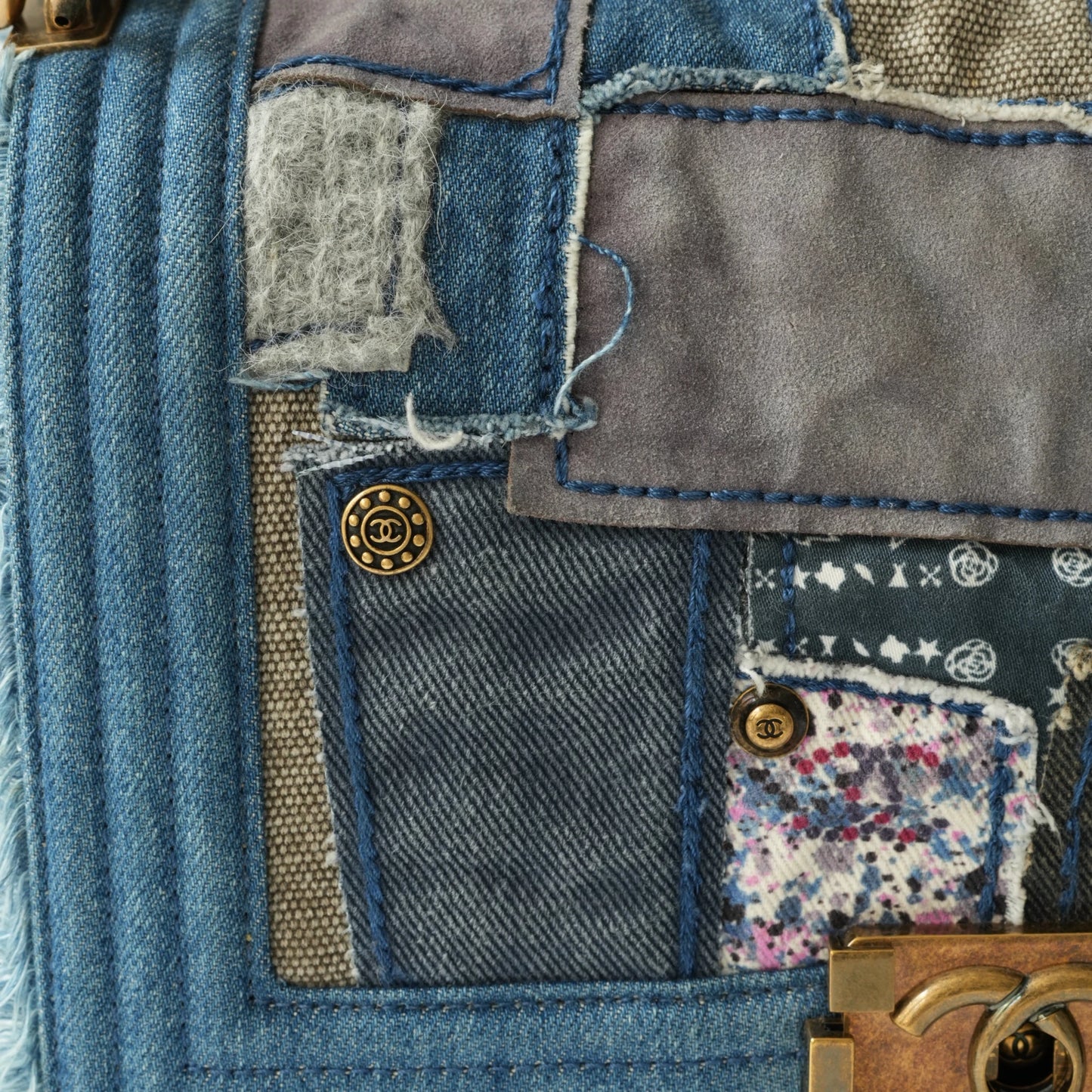 Detail view of aged gold Boy clasp and patchwork denim fabric details