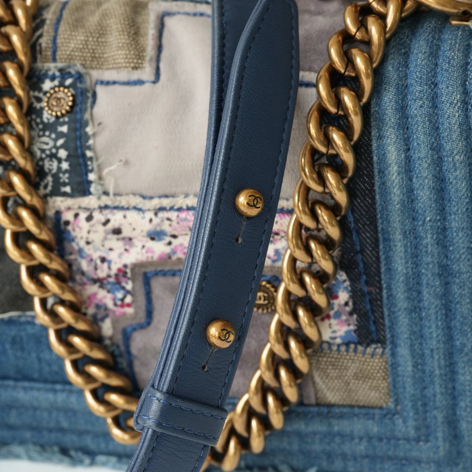 Detail view of aged gold Boy clasp and patchwork denim fabric details