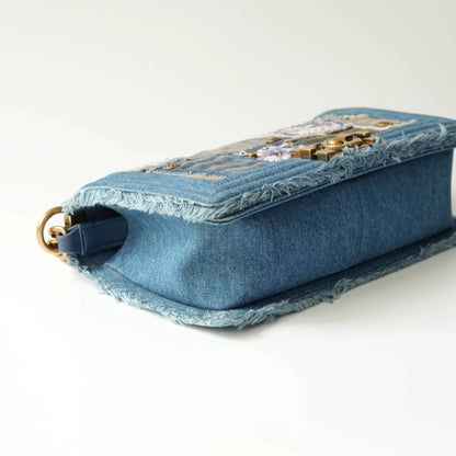Detail view of aged gold Boy clasp and patchwork denim fabric details