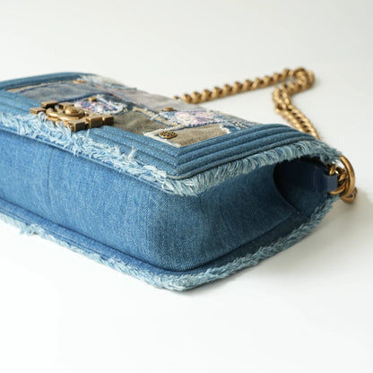 Detail view of aged gold Boy clasp and patchwork denim fabric details