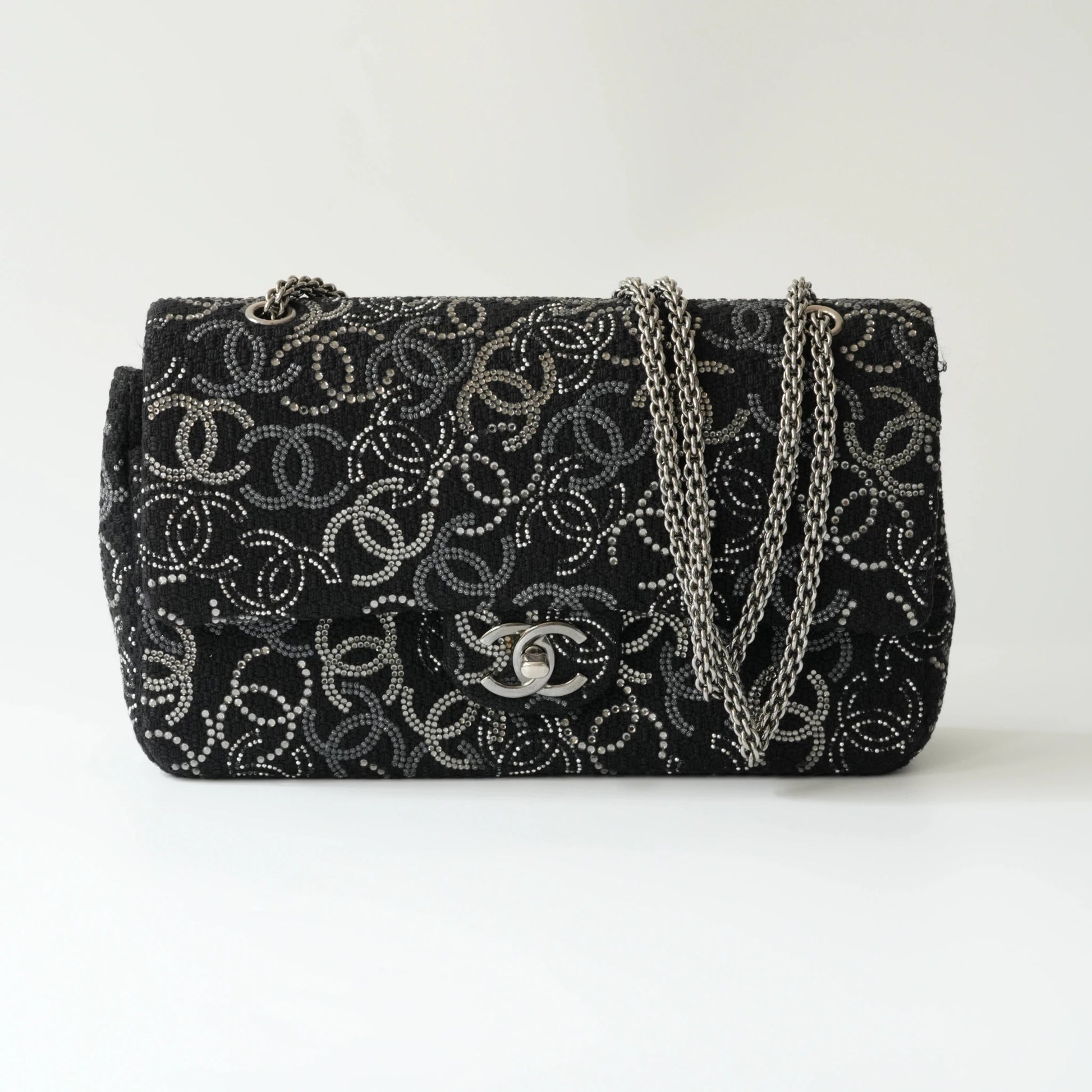 Front view of Chanel classic flap bag with all-over strass crystal CC pattern on black tweed