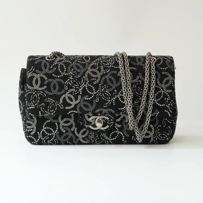 Front view of Chanel classic flap bag with all-over strass crystal CC pattern on black tweed