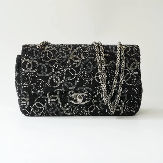 Front view of Chanel classic flap bag with all-over strass crystal CC pattern on black tweed