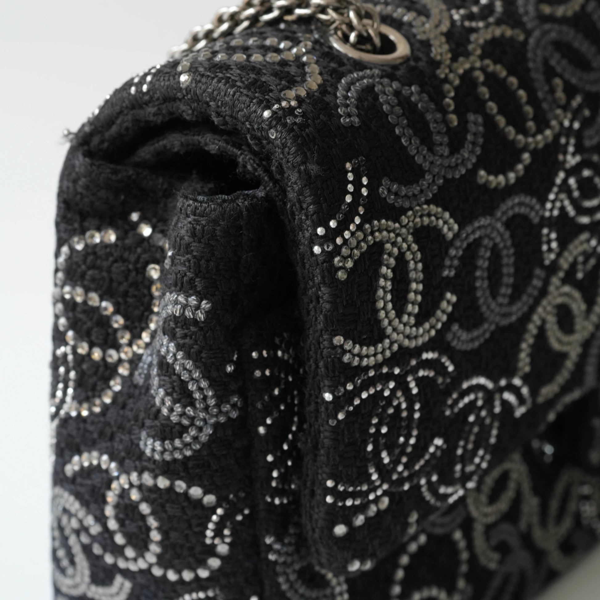 Detail view of silver interlocking CC turnlock and crystal embellishments