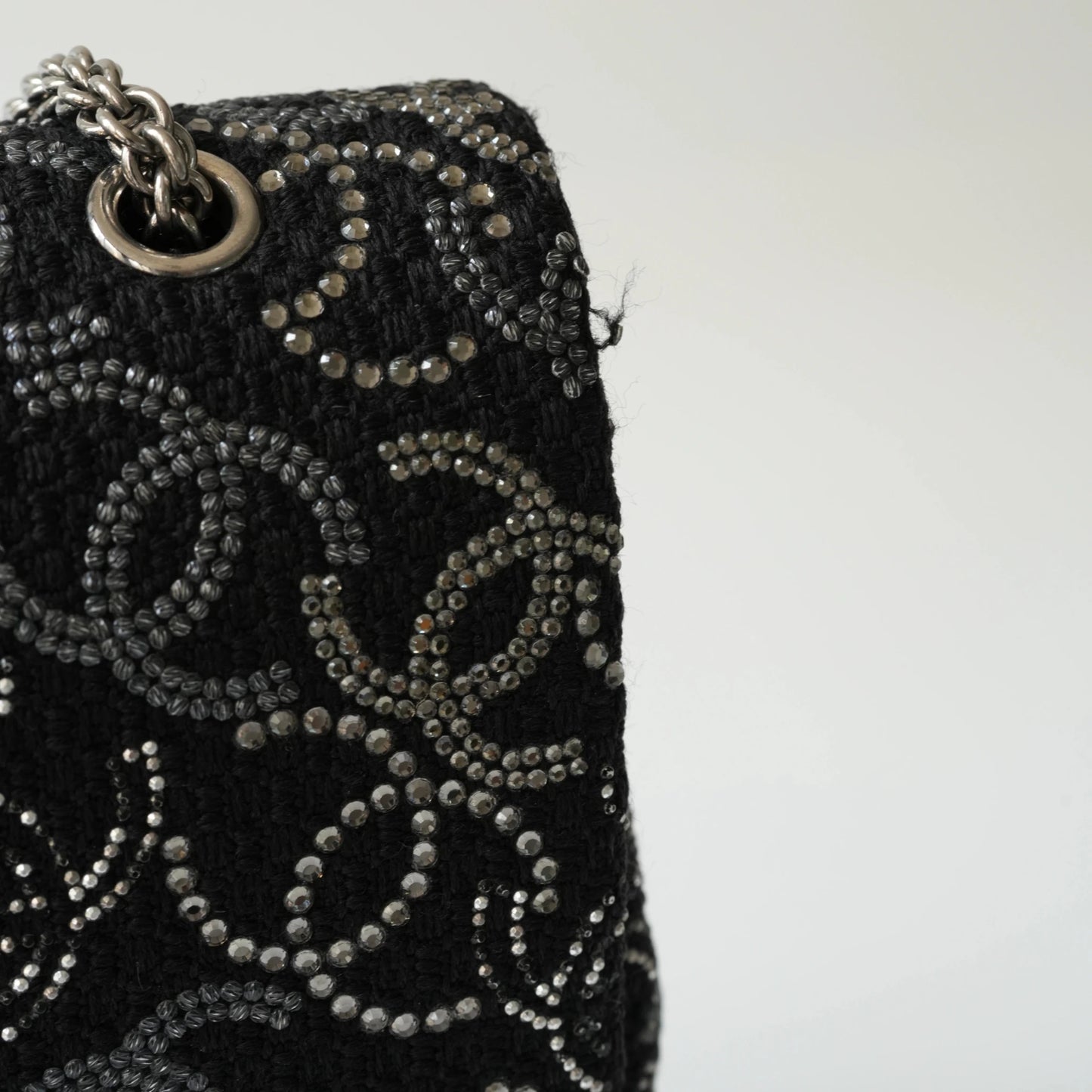 Detail view of silver interlocking CC turnlock and crystal embellishments