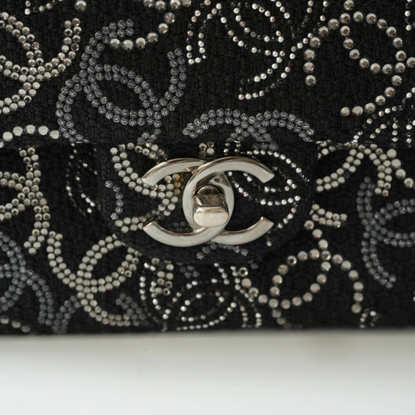 Detail view of silver interlocking CC turnlock and crystal embellishments