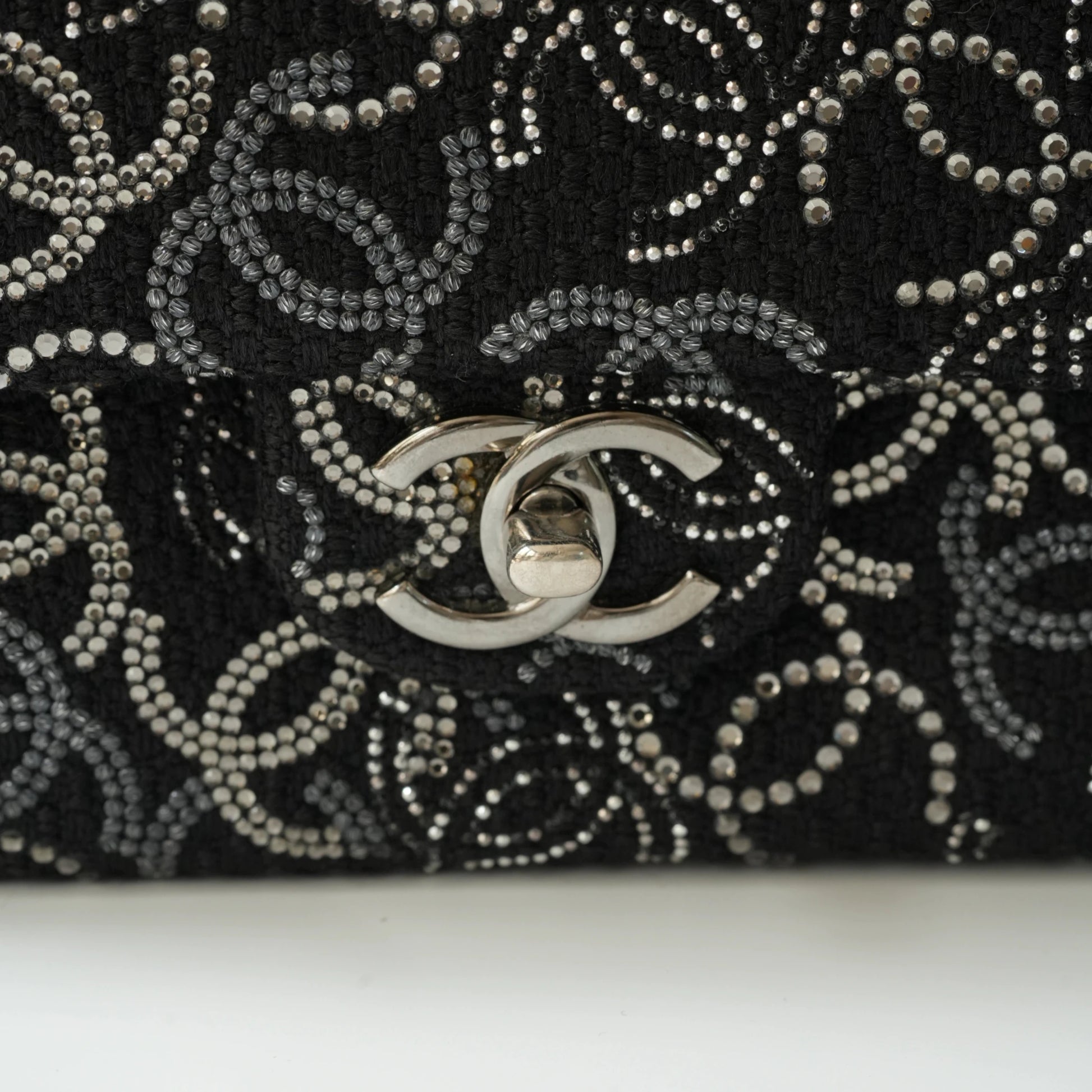 Detail view of silver interlocking CC turnlock and crystal embellishments