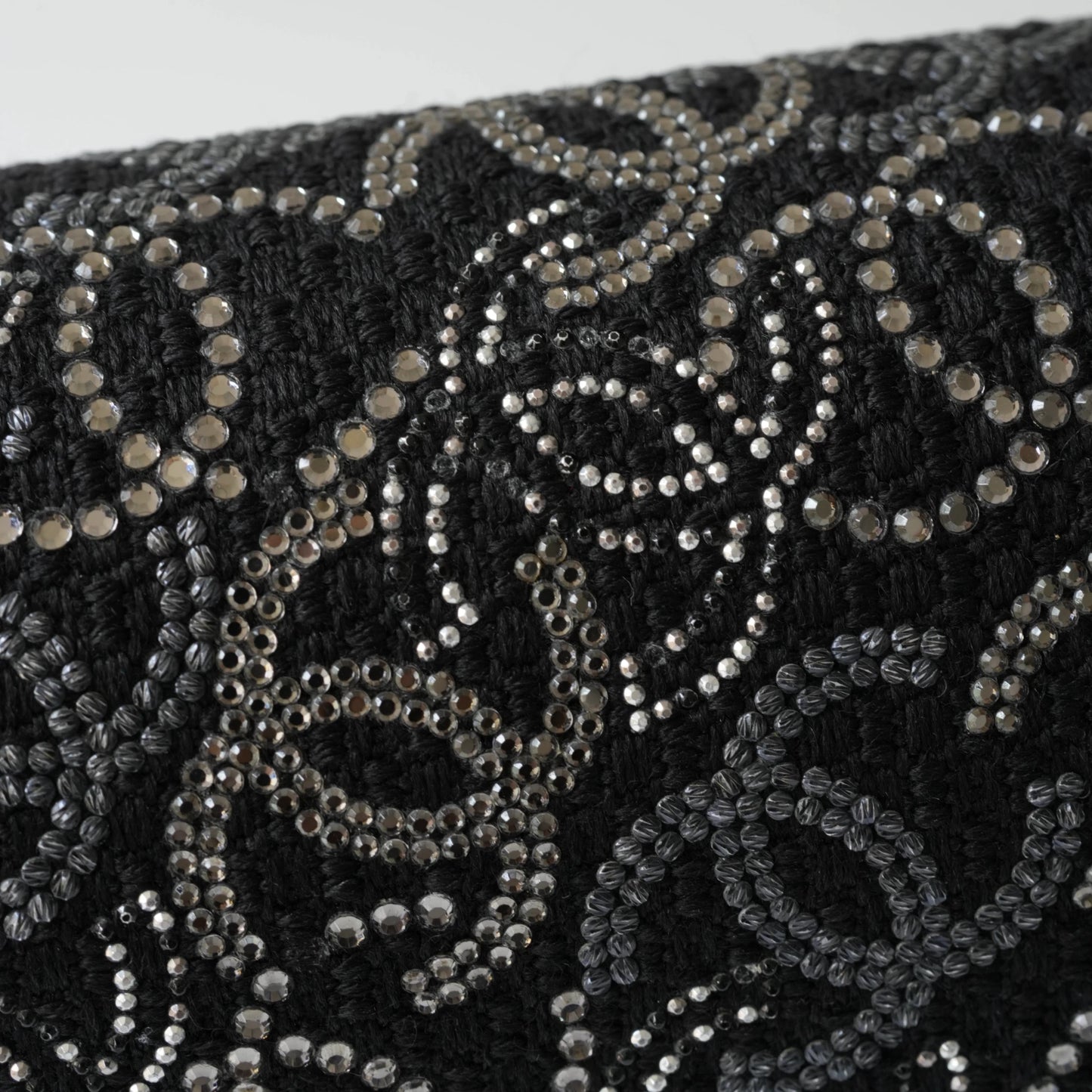 Detail view of silver interlocking CC turnlock and crystal embellishments