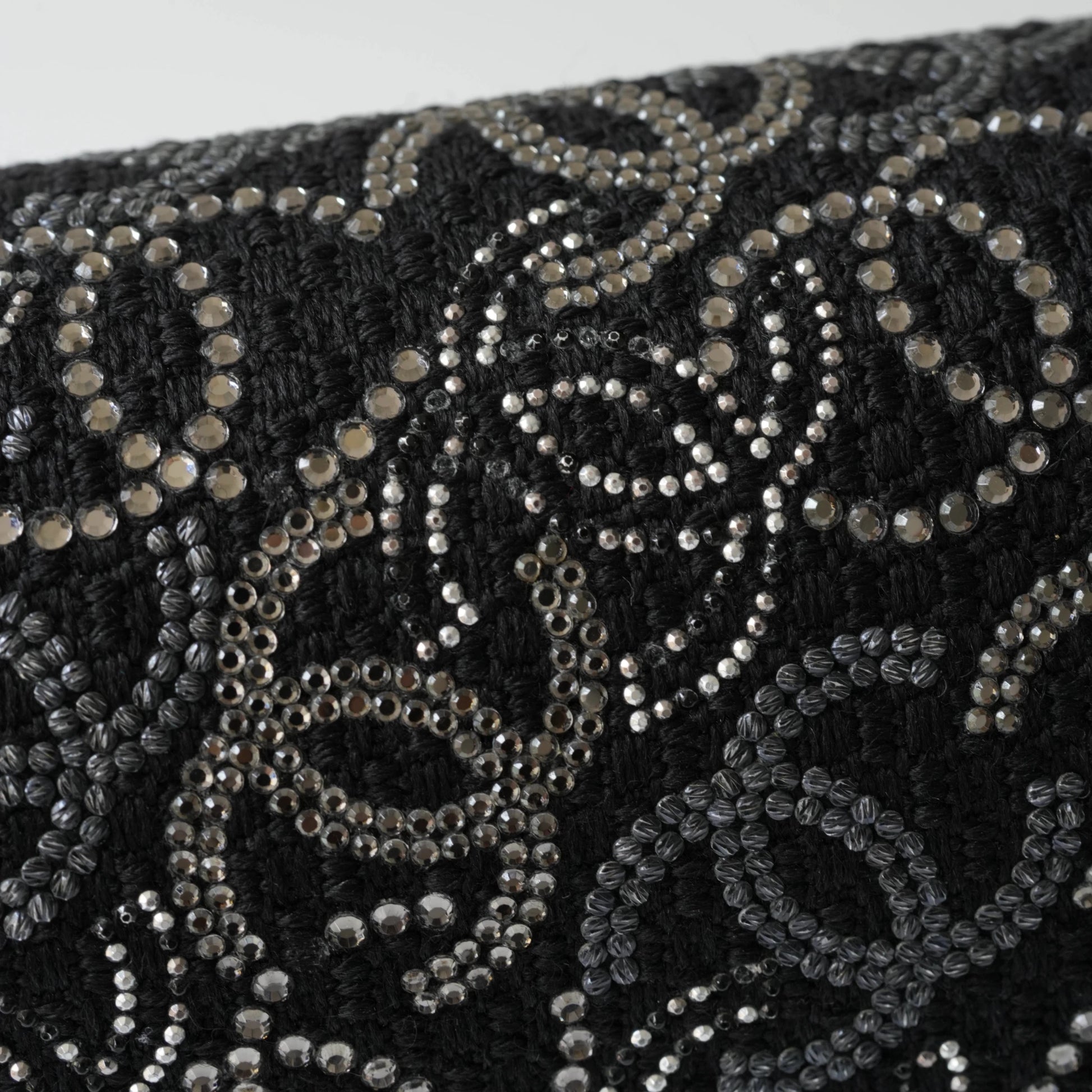 Detail view of silver interlocking CC turnlock and crystal embellishments