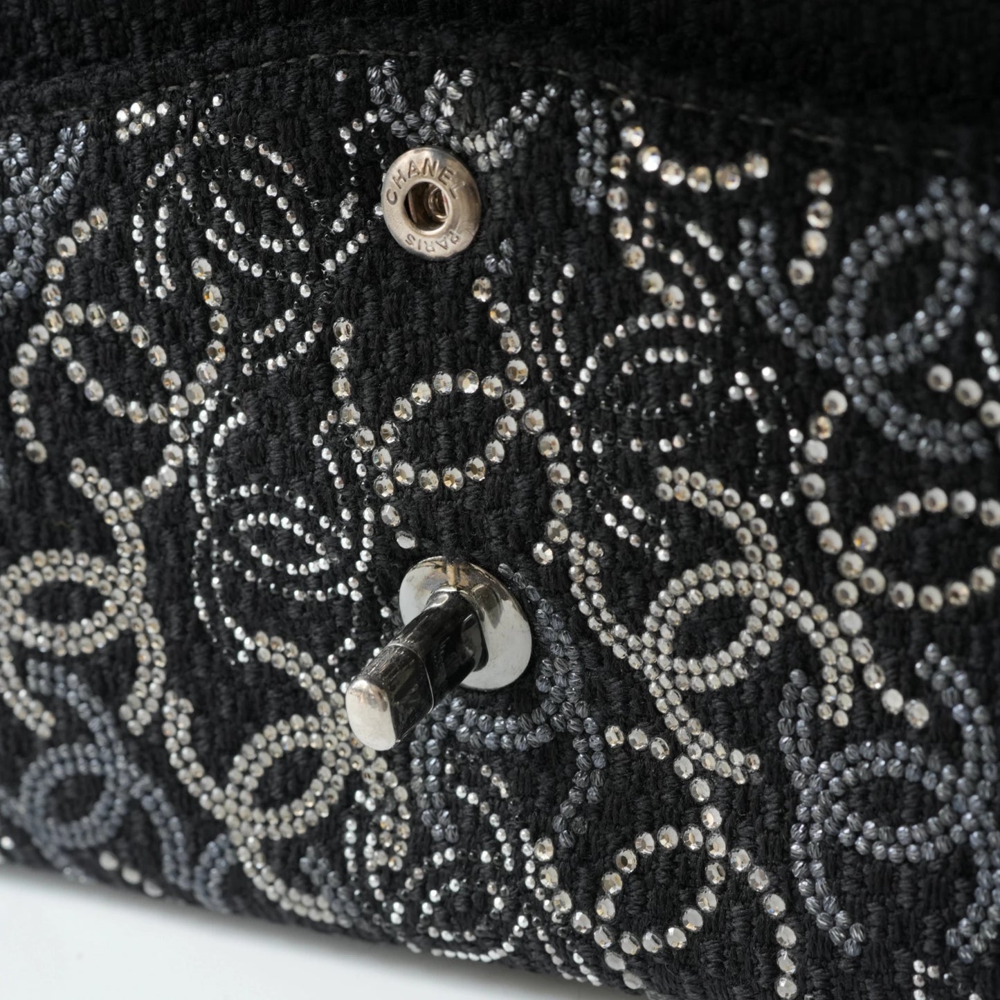 Detail view of silver interlocking CC turnlock and crystal embellishments