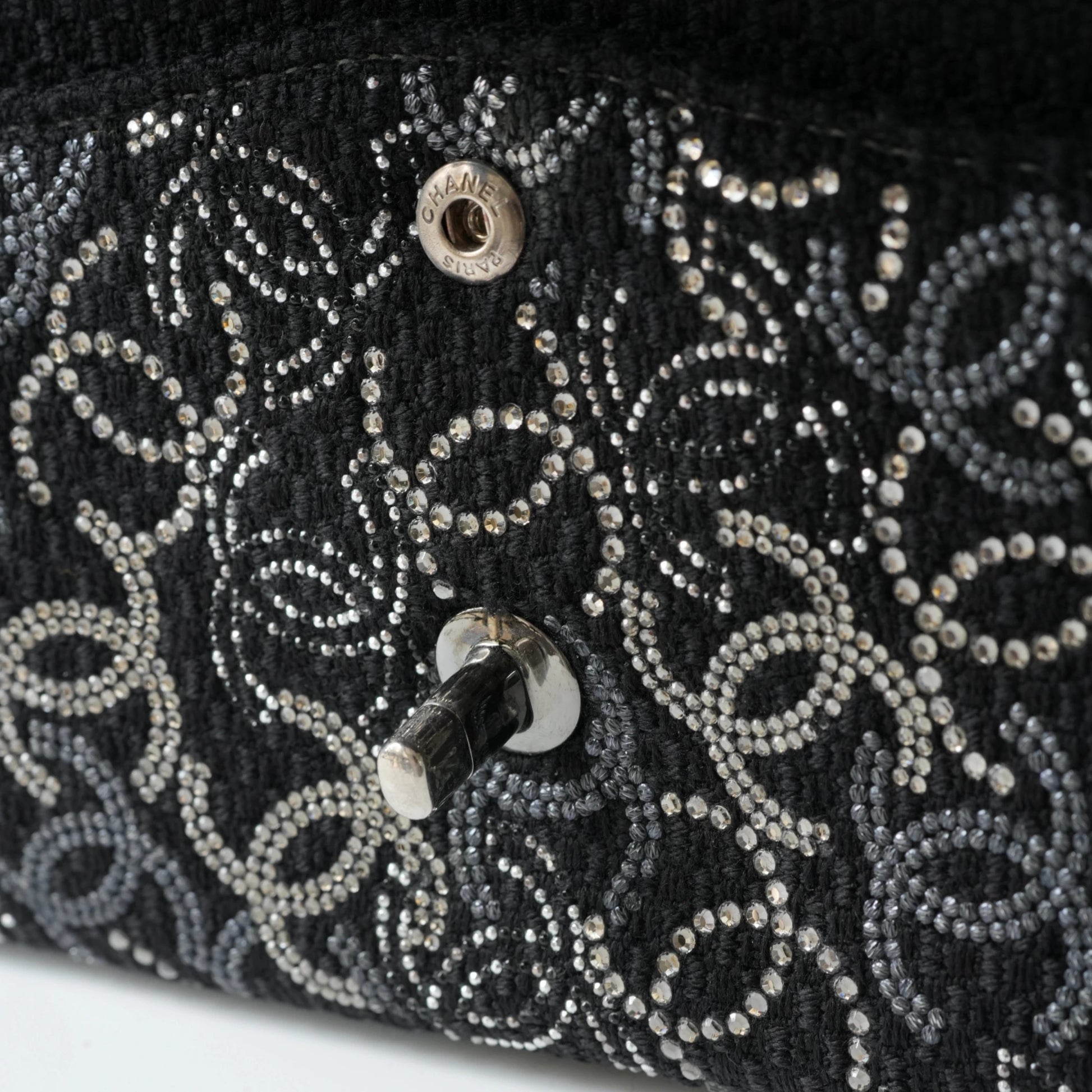 Detail view of silver interlocking CC turnlock and crystal embellishments