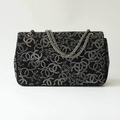 Back view of Chanel classic flap bag in black tweed with crystal CC motif