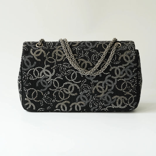Back view of Chanel classic flap bag in black tweed with crystal CC motif