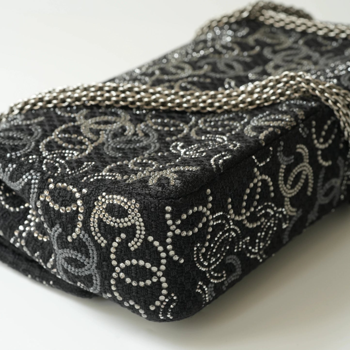 Detail view of silver interlocking CC turnlock and crystal embellishments