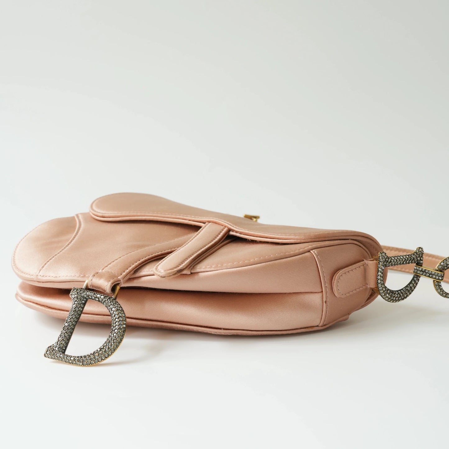 Bottom view of Dior mini saddle bag with curved base structure