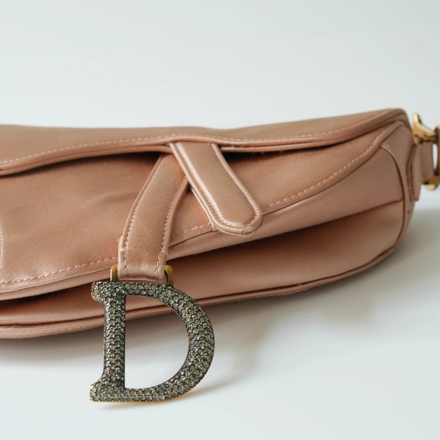 Detail view of crystal-embellished D stirrup charm and CD hardware